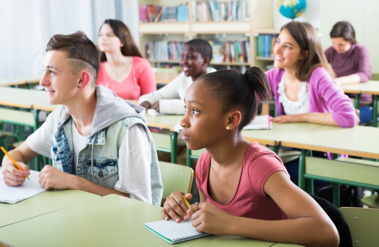 Students taking notes in class.